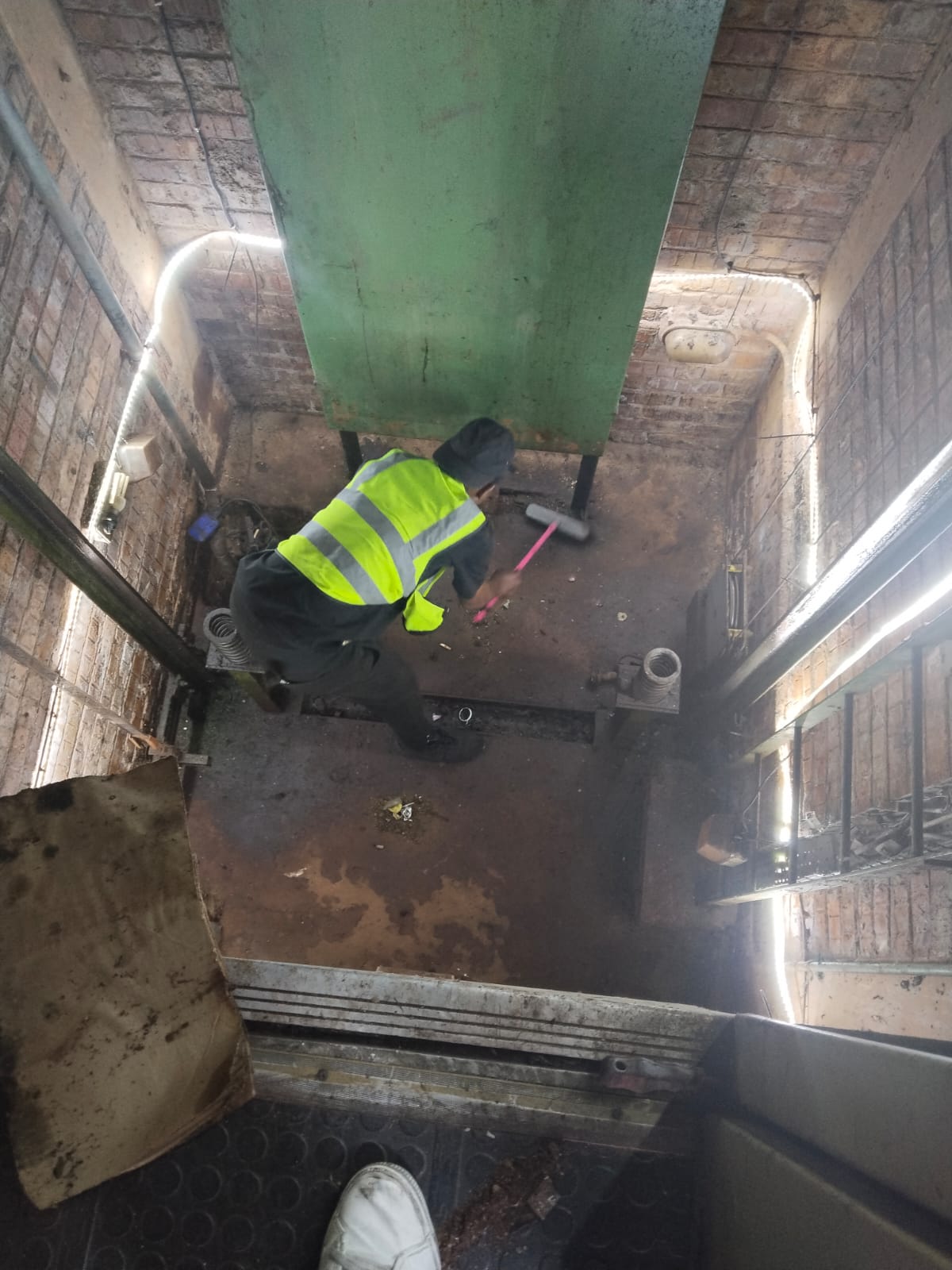 Technician working inside a lift shaft
